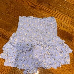 Purple floral ruffled mini skirt with minor rip at back of bottom ruffle